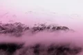 Mountain peaks covered in clouds near the hotel rooms in Switzerland.