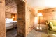 Spacious hotel room with wooden decor and cozy seating in Switzerland.
