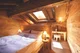 Cozy attic bedroom with a skylight in a hotel room in Switzerland.