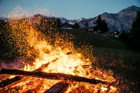 Sparks flying from a bonfire, a warm night while hiking in Switzerland.